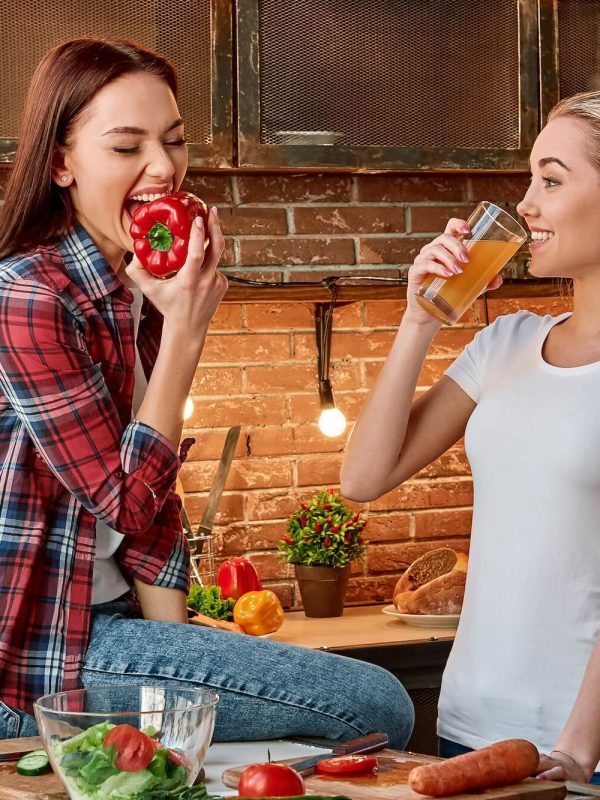 eat-well-to-be-well-young-female-friends-preparing-together-healthy-meal-in-modern-kitchen-cozy-1.jpg